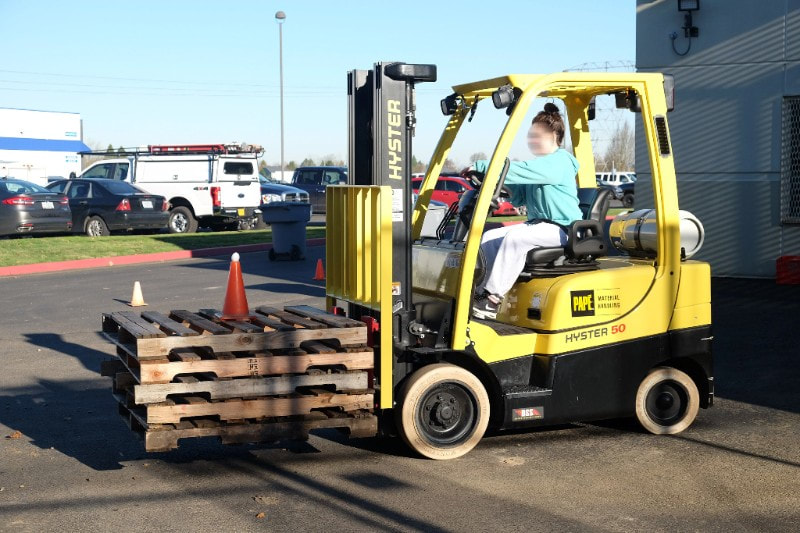 Student learning to drive forklift