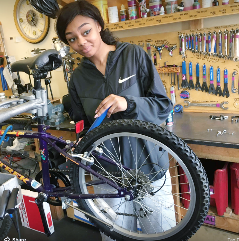 Student repairing bicycle